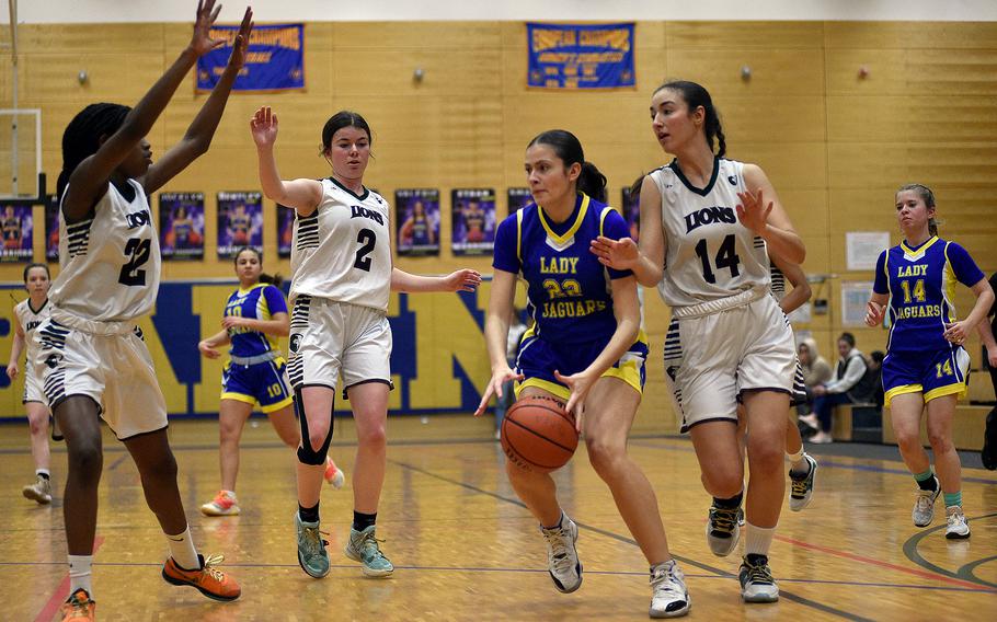 Sigonella senior Anabel Vaiciulis picks up the ball around AFNORTH defenders, from left, Makayla McNiell-Mark, Finja Liebing and Maggie Masse during a Division III semifinal at the DODEA European Basketball Championships on Feb. 16, 2024, at Wiesbaden High School in Wiesbaden, Germany.