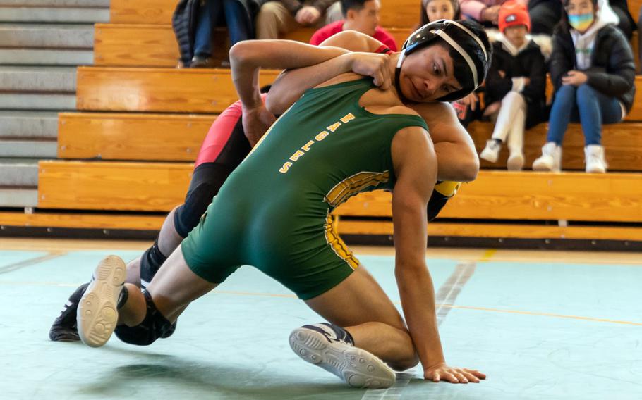 Nile C. Kinnick's Samuel Tovar battles for position against Robert D. Edgren's Owen Moreno at 129 pounds during Saturday's DODEA-Japan wrestling tri-meet. Tovar won by pin and the Red Devils took the dual meet 53-5.