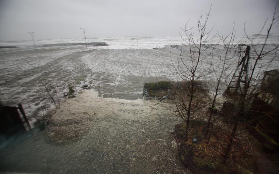 Water from the Bering Sea, pushed by high winds, rushes into a home's backyard in Nome, Alaska, on Saturday, Sept. 17, 2022. 