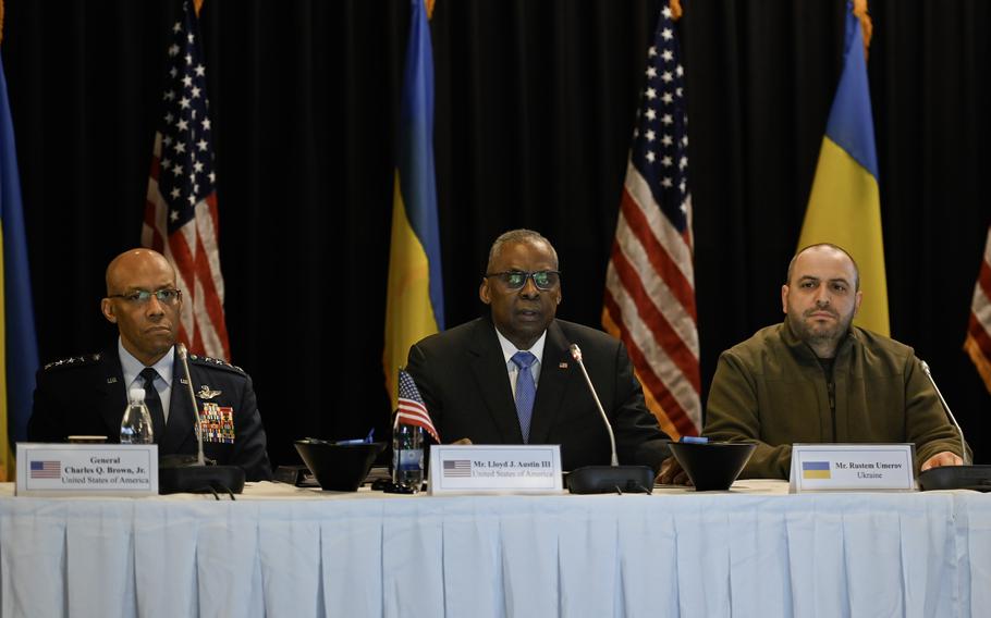 U.S. Defense Secretary Lloyd Austin gives opening remarks next to Ukrainian counterpart Rustem Umerov, right, during the Ukraine Defense Contact Group meetings at Ramstein Air Base, Germany, Tuesday, March 19, 2024. Gen. Charles Q. Brown, left, attends his first in-person UDCG meeting as the chairman of the joint chiefs of staff, following the retirement of his predecessor, Gen. Mark Milley, in September.