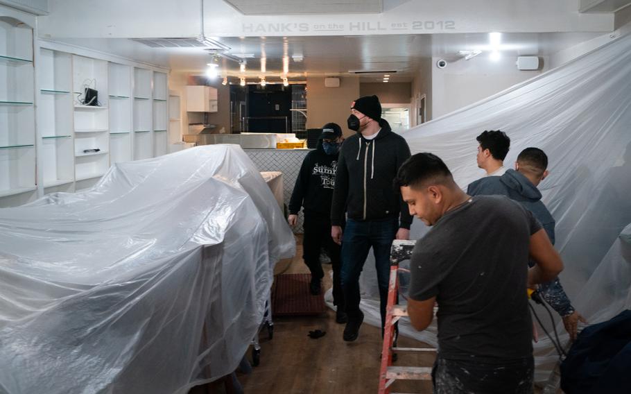 Fight Club co-owner, Andrew Markert, front, and Bart Hutchins walk through the restaurant as workers are preparing to paint. 
