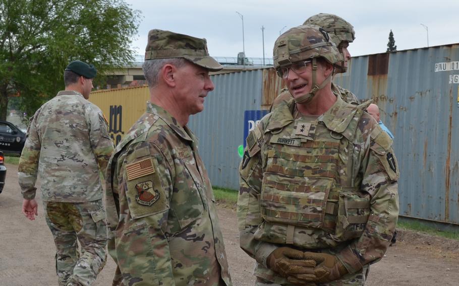 Maj. Gen. Thomas Suelzer, the Texas adjutant general, speaks with Maj. Gen. Ronald “Win” Burkett, commander of the 36th Infantry Division, on May 23, 2022, during a visit to Texas National Guard members deployed in Eagle Pass on a state-sponsored mission to the border with Mexico. 