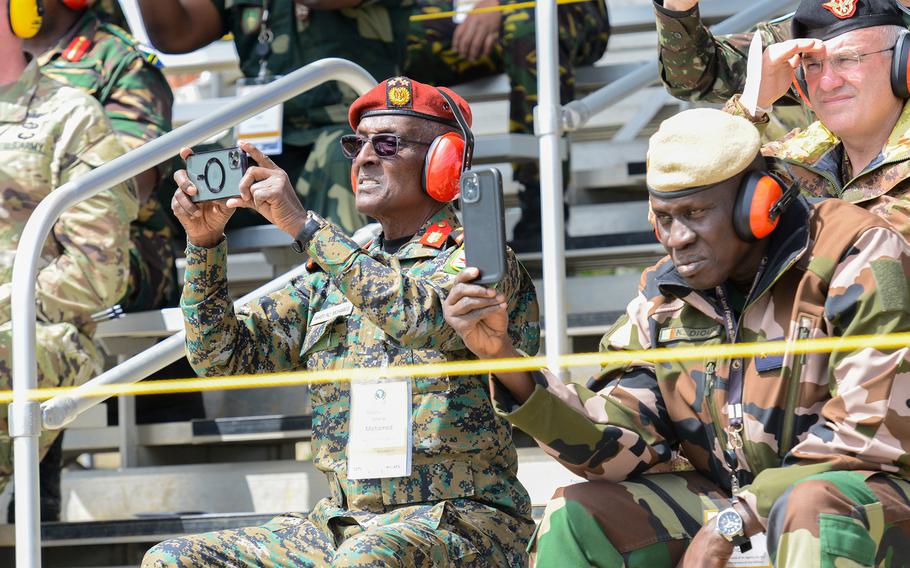 Maj. Gen. Taher Ali Mohamed, the deputy chief of defense for Djibouti, left, and Senegal’s Brig. Gen. Khar Diouf, right, video a U.S. Army live-fire demonstration at the Red Cloud Range at Fort Benning, Ga., on March 24, 2022, during the African Land Forces Summit. The demonstration included demonstrations of infantry and armor tactics, including the firing of mortars, machine guns, and heavy weapons from armored Stryker and Bradley infantry vehicles and Abrams tanks.