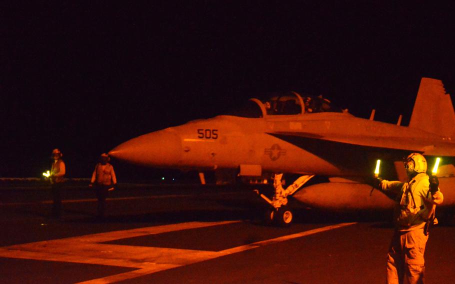 An F-18 taxis aboard the USS Carl Vinson during a multi-carrier exercise in the Philippine Sea, Sunday, Nov. 5, 2023. 