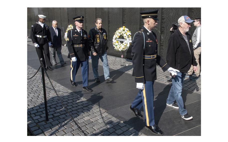 Participants in a wreath-laying ceremony arrive at the Vietnam Wall on National Vietnam War Veterans Day in Washington, D.C., March 29, 2024.