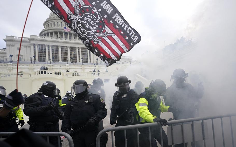 In this Jan. 6, 2021, U.S. Capitol Police officers hold off rioters loyal to President Donald Trump at the Capitol in Washington.
