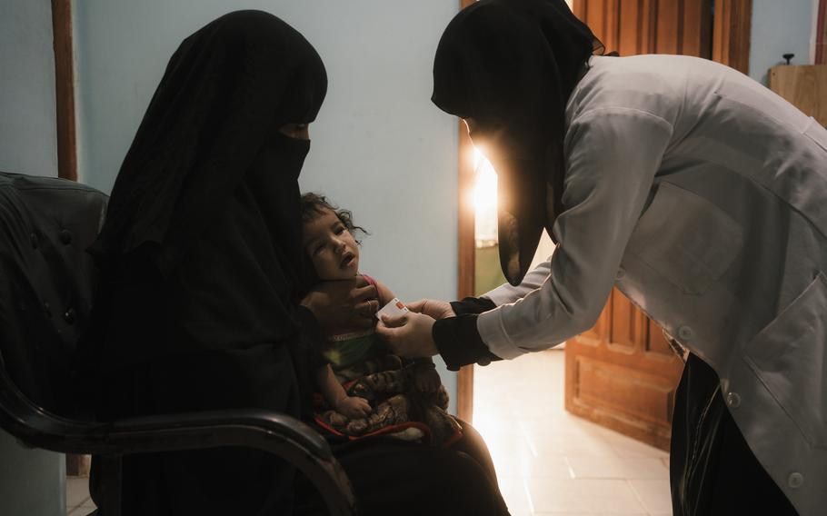 Bushra Ali Sagheer Surban gets treatment for Reena at a hospital in Hajjah city. 