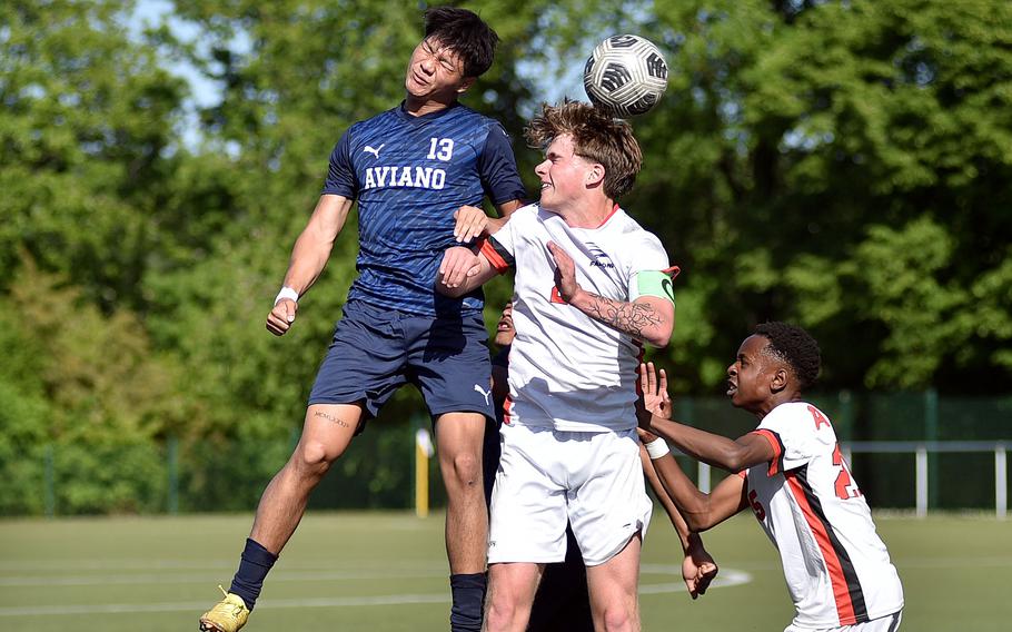 Aviano’s Joseph Guerrero heads the ball over American Overseas School of Rome central midfielder Riley Smith during the first day of pool-play action at the 2025 Division II DODEA European championships at the stadium of VfB Reichenbach on May 19, 2025, in Reichenbach-Steegen, Germany.