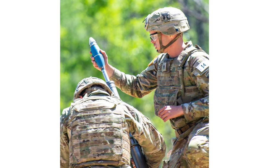 A mortar team from the 101st Airborne Division loads a 60mm mortar during the second day of the U.S. Army’s Best Mortar Competition at Fort Benning, Ga., on Tuesday, April 11, 2023. 