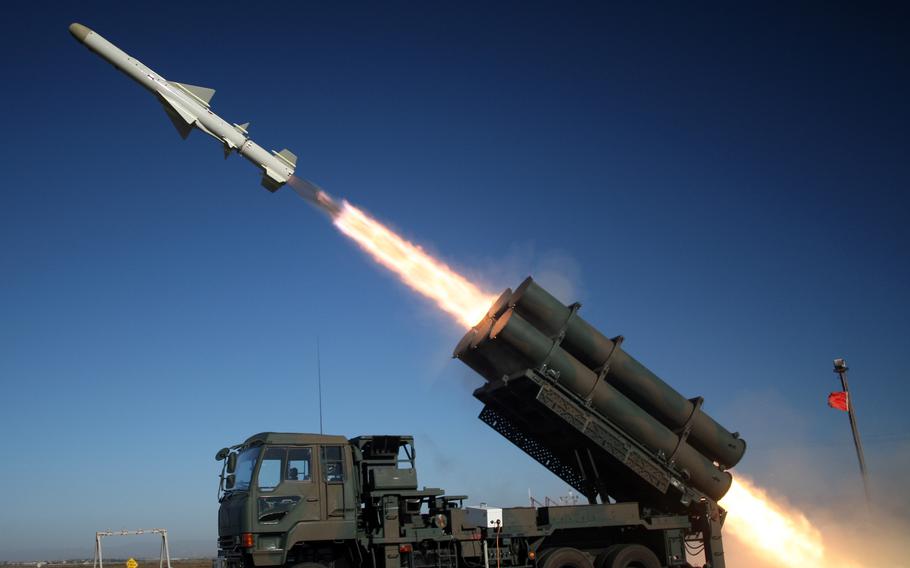 Japanese  soldiers fire a Type-88 missile.