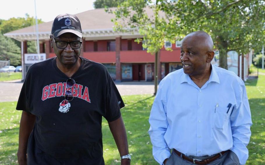 Alonzo Senior, left, and Michael Atkins walk through Kirk Park discussing plans for a military memorial for people of color.