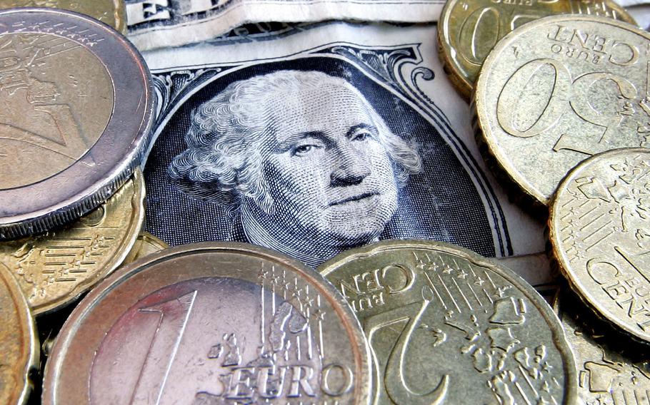 Euro coins and dollar bills are seen in Frankfurt, Germany. The U.S. dollar has been surging in 2022, so much that it’s nearly equal in value to the euro for the first time in 20 years.