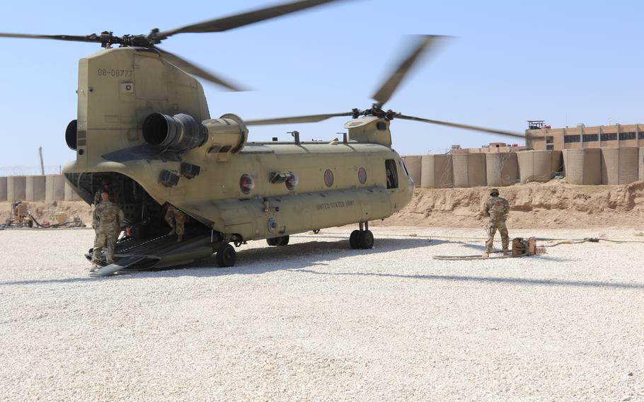 A Task Force Phoenix CH-47 Chinook helicopter from B Company, 1st Battalion, 171st Aviation Regiment (General Support Aviation Battalion), sits on the landing pad at a forward operating base in Syria.