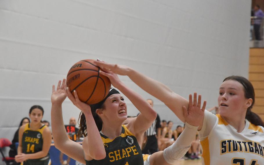 Stuttgart’s Ella Kirk gets a hand on the ball before SHAPE’s Jessie Moon can shoot it in a Division I semifinal at the DODEA European Basketball Championships in Wiesbaden, Germany.
