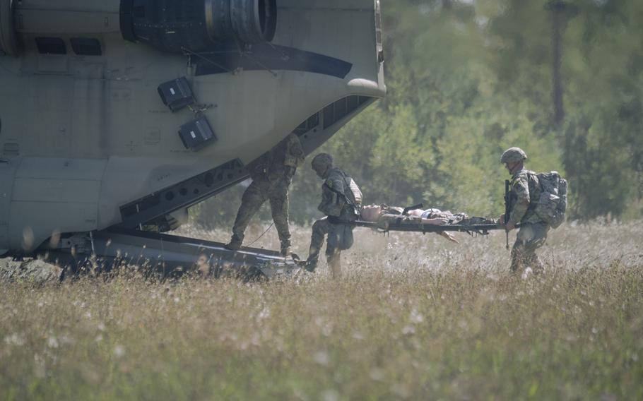 Soldiers climb into the helicopter.