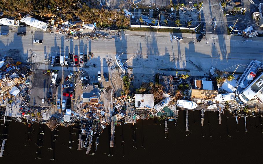 Washed-up boats and debris are strewn across the roadway in Fort Myers Beach, Fla., following Hurricane Ian in September. 