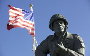The statue of Maj. Dick Winters of Easy Company, 506th Parachute Infantry Regiment, 101st Airborne Division, stands as reminder of the sacrifice of the Greatest Generation near Utah Beach, Normandy, France, June 7, 2015. Over 380 service members from Europe and affiliated D-Day historical units are participating in the 71st anniversary as part of Joint Task Force D-Day 71. The task force, based in Sainte Mere Eglise, France, is supporting local events across Normandy, from June 2-8 , 2015 to commemorate the selfless actions by all the allies on D-Day that continue to resonate 71 years later. (U.S. Army photo by Sgt. Austin Berner/Released)