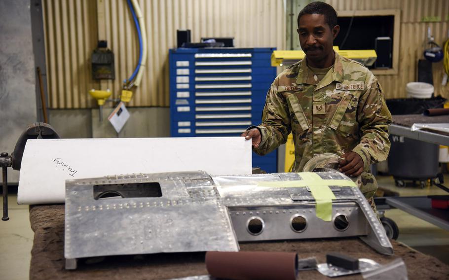 Air Force Tech. Sgt. Steven Green, the 374th Maintenance Squadron's fabrication flight chief, shows off training materials at his shop on Yokota Air Base, Japan, July 28, 2023.