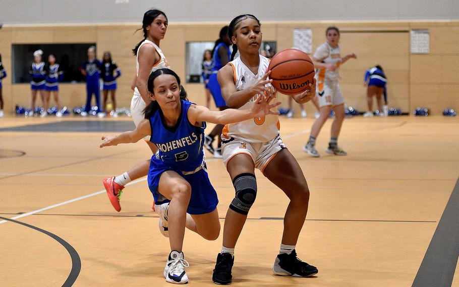 Hohenfels' Anastasia Felix reaches in while Sentinel Aniya Robinson tries to catch a pass during a basketball game on Jan. 26, 2024, at Spangdahlem High School in Spangdahlem, Germany.