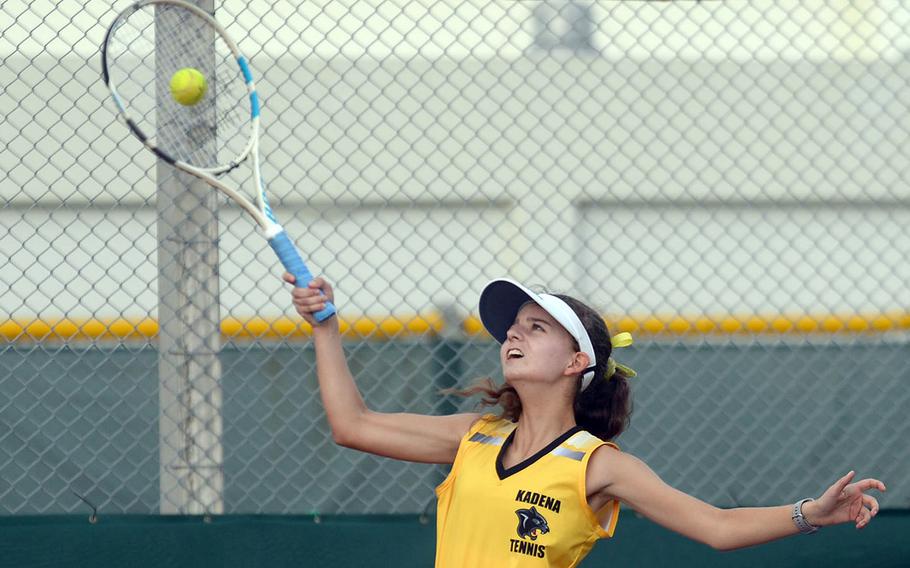 Kadena's Megan Fife hits an overhead smash during Wednesday's Okinawa tennis matches. Fife and teammate Elizabeth Cheramie beat Kubasaki's Lillian Law and Faith Reilly 8-6.