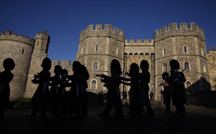 Members of the British Military’s 1st Battalion Grenadier Guards take part in the changing of the guard ceremony outside Windsor Castle in Windsor, England, where Prince Andrew’s residence is nearby in the grounds of Windsor Great Park, Thursday, Jan. 13, 2022. 