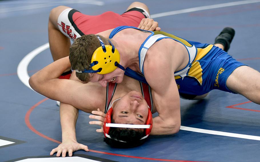 Kaiserslautern's Sergio Dionicio tries to get out of Wiesbaden's Jens Bishop's grip during a 165-pound match on Saturday at Ramstein High School on Ramstein Air Base, Germany.