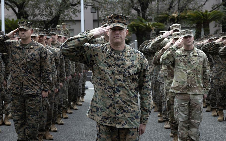 U.S. troops salute during an opening ceremony for the Resolute Dragon at Camp Kengun in Kumamoto, Japan, Saturday, Oct. 14, 2023. The 12th Marine Regiment, soon to be known as the 12th Marine Littoral Regiment, is rehearsing stand-in force concepts during the exercise. 