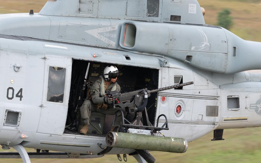 Cpl. Elijah Morales, a UH-1Y Venom Huey crew chief with Marine Light Attack Helicopter Squadron 775, out of Marine Corps Air Station Camp Pendleton, Calif., mans a GAU-21 .50 caliber machine gun mid-flight, during close air supporting training, part of the Northern Strike military exercise in northern Michigan, Aug. 6, 2025.