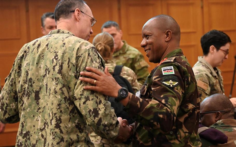 U.S. Special Operations Command Africa leader Rear Adm. Ronald Foy chats with a member of the Kenyan military Monday at Silent Warrior 23 in Garmisch-Partenkirchen, Germany. The conference brings together militaries from across Africa to discuss how to counter violent extremist threats.