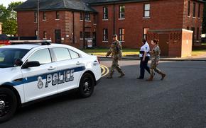 MSgt. Adrienne Clark being escorted after her court martial Satruday at RAF Mildenhall. Clark has been sentenced to 32 months confinement, reduction to E-1 and dishonorable discharge after being found guilty of various UCMJ violations including possession of child pornography and sexual abuse of a child. 