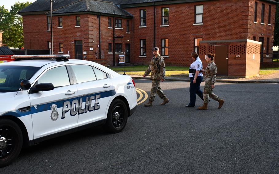 Air Force Master Sgt. Adrienne Clark is escorted from the courtroom Saturday at RAF Mildenhall, England. A jury in her court-martial found her guilty Saturday of possession of child pornography and sexual abuse of a child, among other charges. 