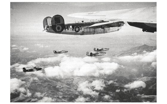 B-24 Liberators from the 460th Bombardment Group fly in formation in 1944. After the B-24 bomber John A. Hutton was navigating got shot down by enemy fire, he was taken prisoner of war and survived months in Nazi-controlled prison camps