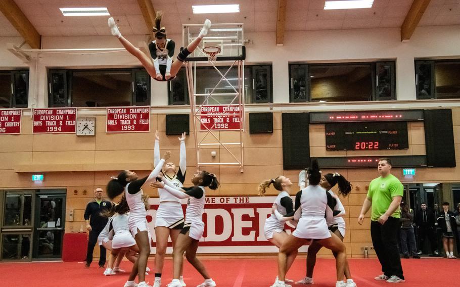 Rachel Turner is thrown into the air by her Stuttgart teammates during the 2023 DODEA-Europe Cheerleading Championships at Kaiserslautern High School on Friday, Feb. 18.