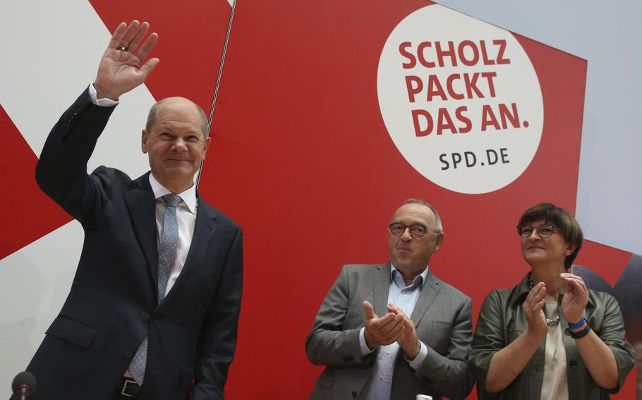 German Social Democratic Party, SPD, party leaders Saskia Esken, right, and Norbert Walter-Borjans, center, applaud  to the party’s candidate for chancellery Olaf Scholz as he arrives at the meeting of the SPD Federal Executive Committee in Berlin, Germany, Monday, Sept. 27, 2021. 