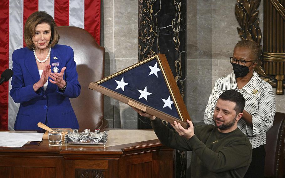 Ukrainian President Volodymyr Zelenskyy receives from then-U.S. House Speaker Nancy Pelosi, left, a U.S. flag during his address to the U.S. Congress at the U.S. Capitol in Washington, D.C., on Dec. 21, 2022. 