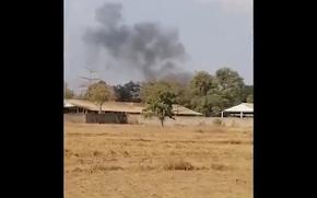 In this image from a video, smoke rises above a distant base, seen from Chbar Mon district in Kompong Speu province, Cambodia Saturday, April 27, 2024. An ammunition explosion at a base in southwestern Cambodia on Saturday afternoon killed multiple soldiers and wounded several others, Prime Minister Hun Manet said. (Chim Sothea via AP)