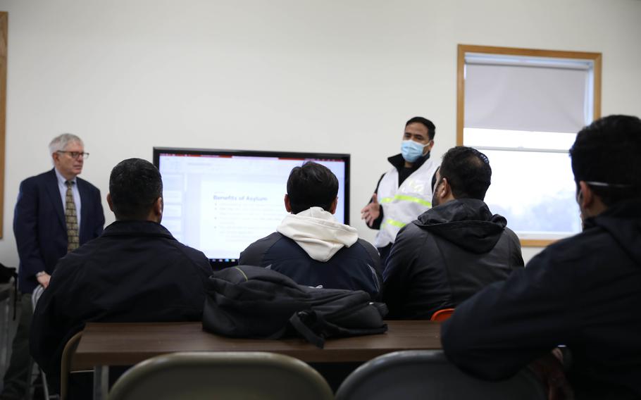 Afghan evacuees attend a class Dec. 15, 2021, at Fort McCoy, Wis., on applying for asylum. The Defense Department now is asking companies to submit proposals on how they can help in verifying past employment for Afghans still seeking Special Immigrant Visas.