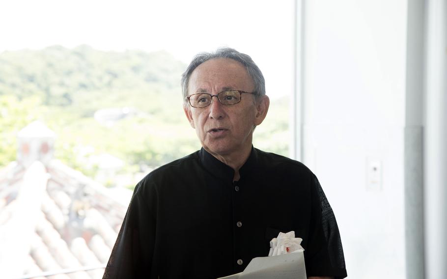 Okinawa Gov. Denny Tamaki speaks to reporters.