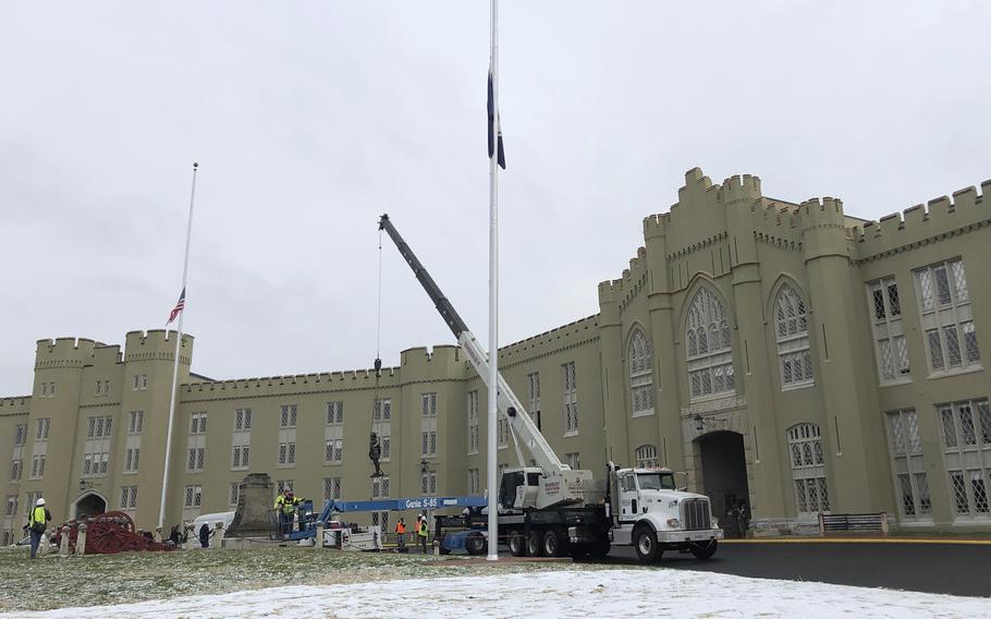 Crews lift a statue of Confederate Gen. Thomas "Stonewall" Jackson from its pedestal on the campus of the Virginia Military Institute in Lexington, Va., on Dec. 7, 2020.