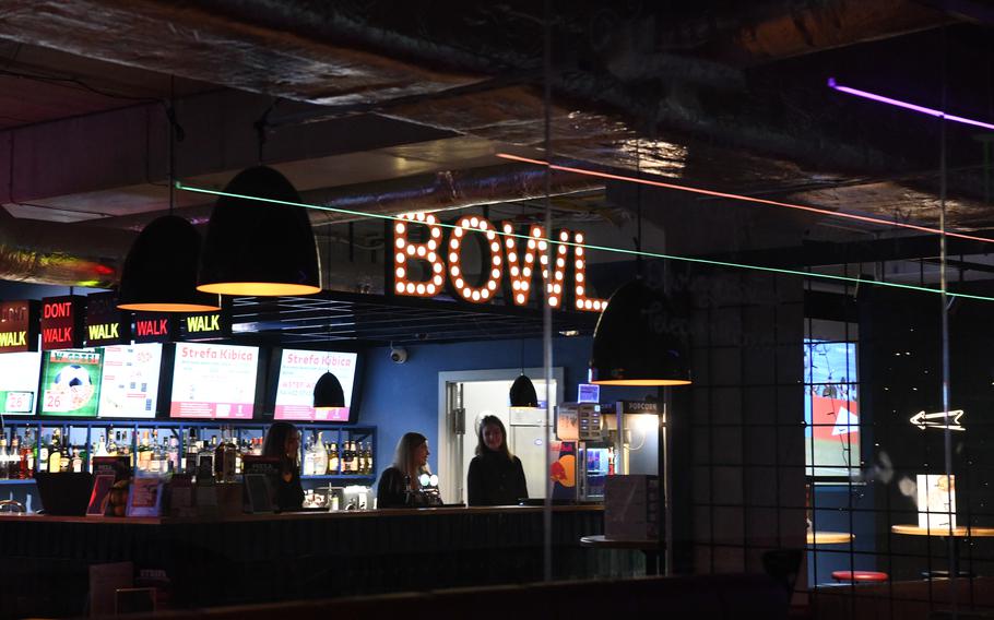 Roksana Borcz, right, works her job at a bowling alley frequented by U.S. troops in Boleslawiec, Poland. Borcz said the American military presence in the town makes her feel safer.