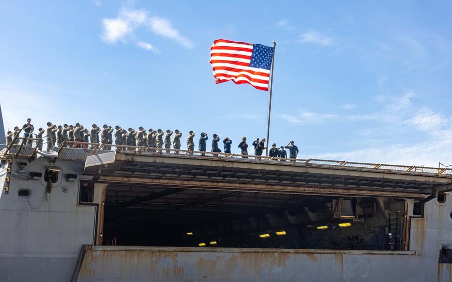 Marines and sailors aboard San Antonio-class amphibious transport dock ship USS Mesa Verde (LPD 19) salute the ship’s colors after returning from deployment with the 26th Marine Expeditionary Unit (Special Operations Capable), Morehead City, N.C., Sunday, March 17, 2024.