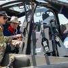 Army Warrant Officer 1 Bobby Keen, an AH-64 Apache pilot, shows Vietnam War pilots around the inside of an Apache on April 25, 2025 during a reunion of 3rd Squadron, 17th Cavalry Regiment troopers who served in Vietnam. The Vietnam veterans spent time with current members of their old unit, including Keen, which is now stationed at Hunter Army Airfield in Savannah, Ga. (Corey Dickstein/Stars and Stripes)
