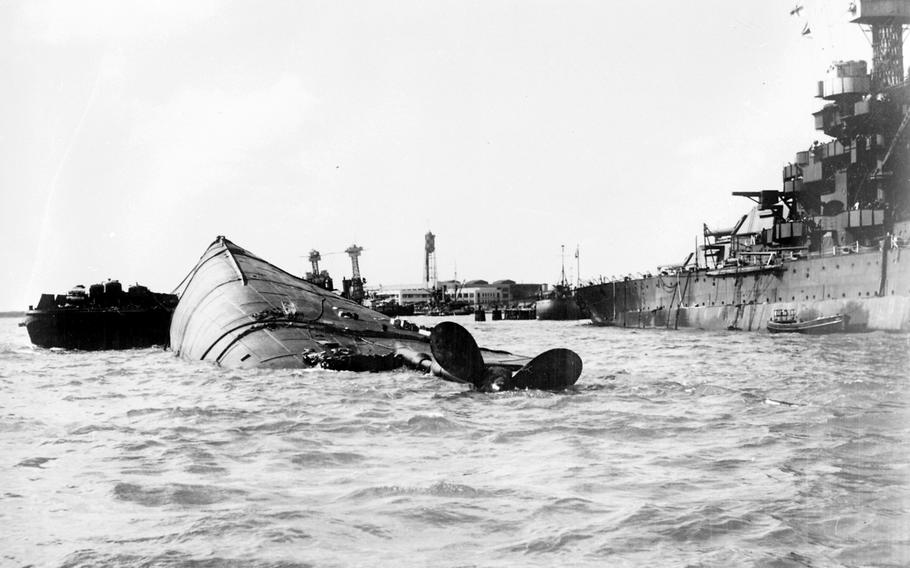 The battleship USS Oklahoma capsizes at Pearl Harbor, Hawaii, Dec. 7, 1941.