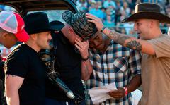 U.S. Marine Sergeant Tyler Vargas-Andrew, center, is consoled his Marine Corps Brothers in Arms Daulton Hannigan, Caden Cooper, and Jorge Mayo, who served in his unit in Kabul, as hes moved to tears during a ceremony at the Folsom Pro Rodeo on Sunday.