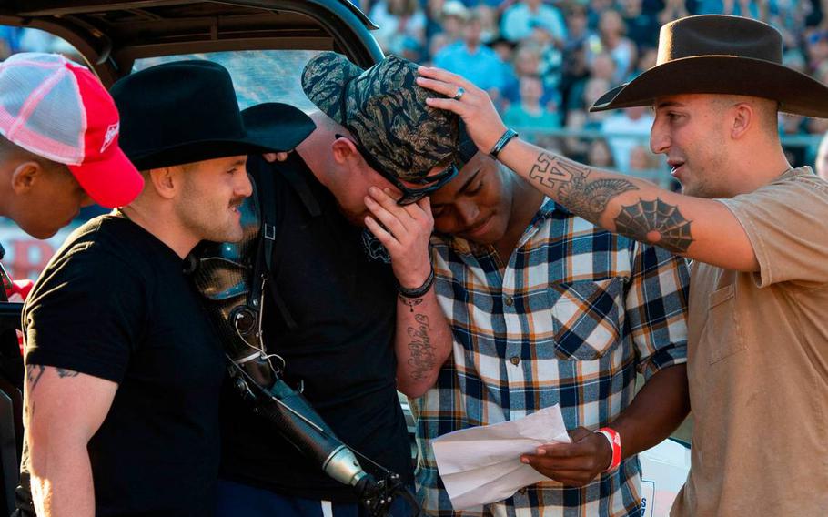 U.S. Marine Sergeant Tyler Vargas-Andrew, center, is consoled by fellow Marines Daulton Hannigan, Caden Cooper and Jorge Mayo, who served in his unit in Kabul, as he’s moved to tears during a ceremony at the Folsom Pro Rodeo on Sunday, July 3, 2022.