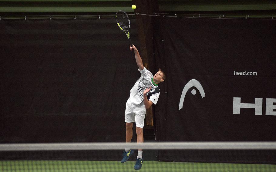Naples’ Kai Baraniak serves during a match between himself and fellow Wildcat Tavi Shah and Kaiserslautern’s Isaac Holly and Bryan Oh in pool-play action of the DODEA European tennis championships on Oct. 19, 2023, at T2 Sports Health Club in Wiesbaden, Germany.