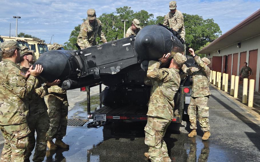 Soldiers in Tallahassee, Fla., on Aug. 29, 2023, prepare boats for search and rescue missions after Hurricane Idalia strikes the west coast of Florida from the Gulf of Mexico.