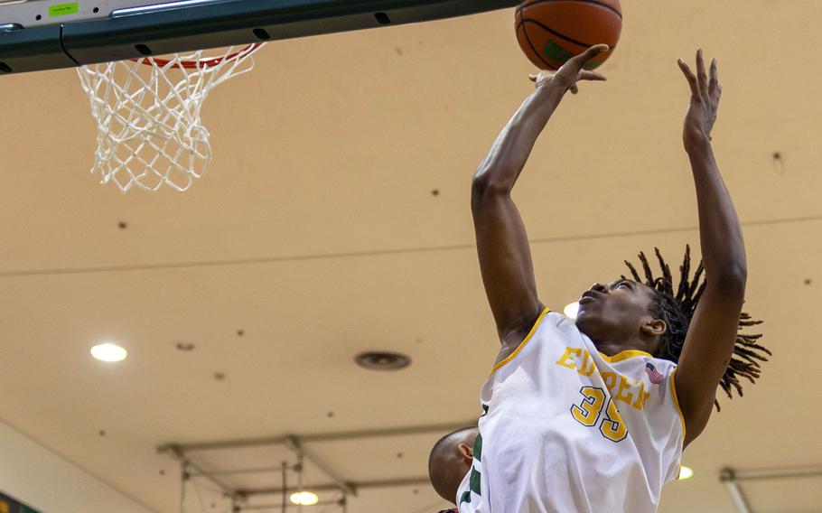 Robert D. Edgren's JaShawn Spaighs-Pace shoots against Nile C. Kinnick's defense during Friday's DODEA-Japan boys basketball game. The Red Devls won 80-78.