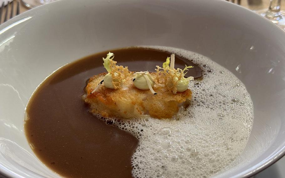 Fried whitefish meets rich broth and a hint of wasabi in this layered, comforting starter at Vicino in Kaiserslautern, Germany.