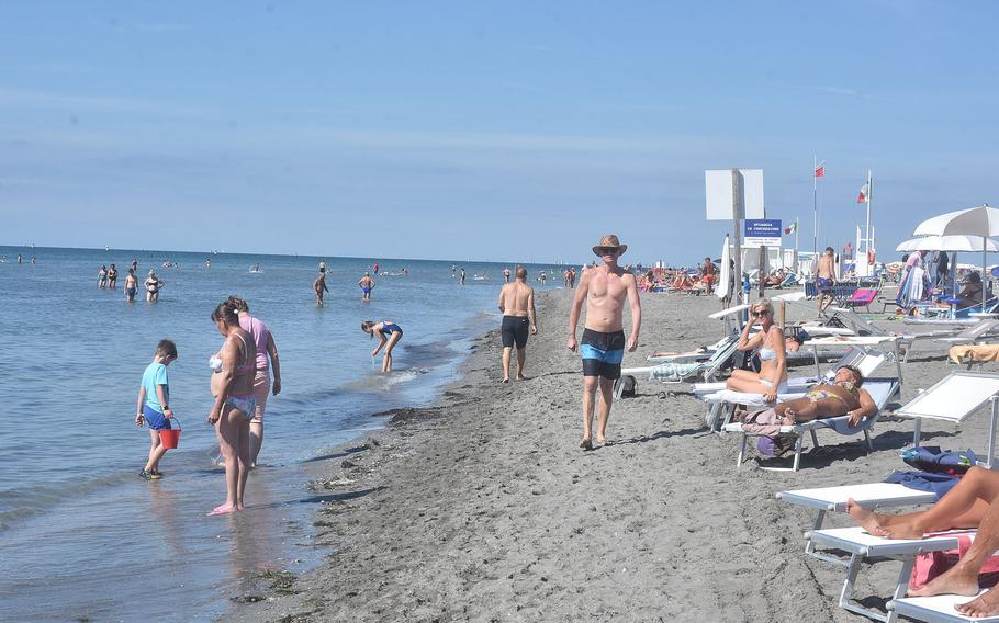 Sunbathers lounge in rented chairs while others cool off in the waters of the Adriatic Sea on one of the largest beaches in Grado, Italy. The city, a popular place for Germans and Austrians every summer, is just about an hour’s drive from Aviano Air Base.